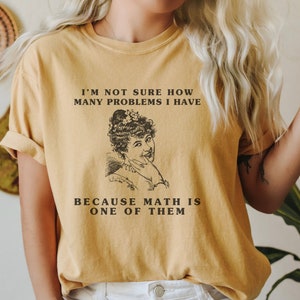 model is wearing Comfort Colors oversized tee shirt in mustard with girl math graphic on front