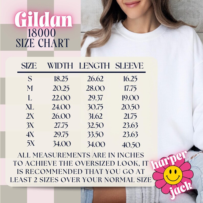 May include: A white Gildan 18000 sweatshirt size chart with measurements in inches. The chart includes sizes S to 5X, with width, length, and sleeve measurements. The text recommends sizing up for an oversized fit. A pink flower logo is in the bottom right.