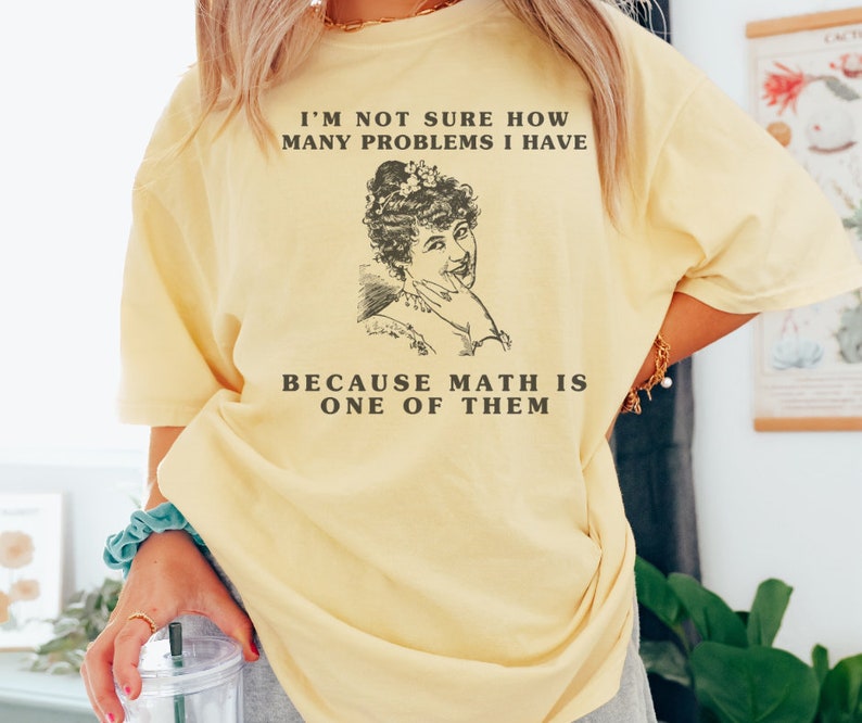 model is wearing Comfort Colors oversized tee shirt in banana (light yellow) with girl math graphic on front
