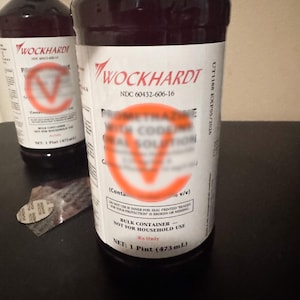 May include: Two dark amber plastic bottles of Wockhardt oral solution, each featuring a white label with red text. The labels display the NDC 60432-606-16 code, the text 'BULK CONTAINER - NOT FOR HOUSEHOLD USE', and a net volume of 1 Pint (473 mL).