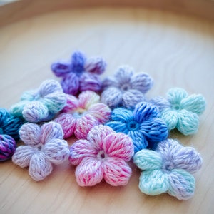 Beautiful & colorful crochet flower in a pile. Puff flowers, regular yarn, rainbow flowers, flower crochet patterns, 2n1 bundle, extra value, dainty, plum, sakura, daisy, spring florals, yarn scrap flowers, yarn scrap projects, easy crochet pattern