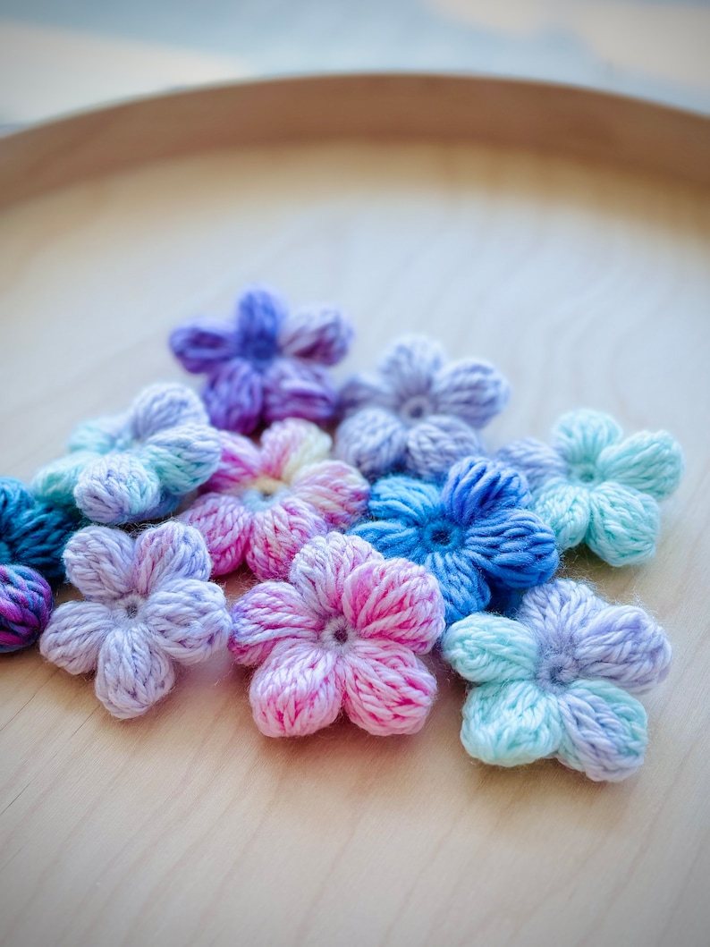 Beautiful & colorful crochet flower in a pile. Puff flowers, regular yarn, rainbow flowers, flower crochet patterns, 2n1 bundle, extra value, dainty, plum, sakura, daisy, spring florals, yarn scrap flowers, yarn scrap projects, easy crochet pattern