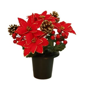 May include: A red poinsettia flower arrangement with gold glitter accents and pine cones in a black pot.