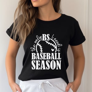 May include: Black t-shirt with a white graphic of a baseball with the text "The only BS I need is Baseball Season".