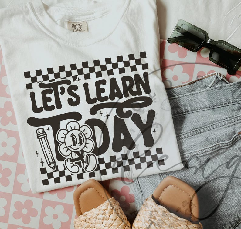 May include: White t-shirt with the text "Let's Learn Today" in black, featuring a pencil and a smiling flower graphic. The shirt is paired with denim shorts, sunglasses, and woven sandals.