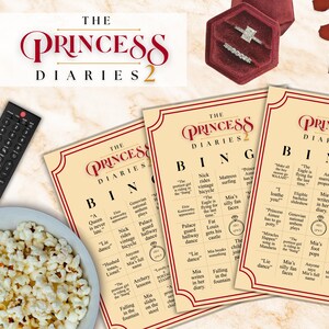 May include: The Princess Diaries 2 themed bingo cards with a remote control and a bowl of popcorn. The bingo cards have a cream background with burgundy text and borders. The movie title is at the top of the cards.