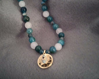 apatite beads, white jade and gold tone evil eye spinner charm