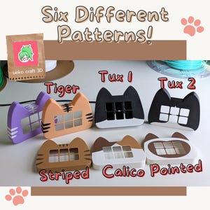May include: Six different 3D printed cat-shaped objects with various patterns, including striped, calico, pointed, tiger, and two tuxedo designs. The objects are arranged in a row on a light brown surface. The text "Six Different Patterns!" is written above the objects.