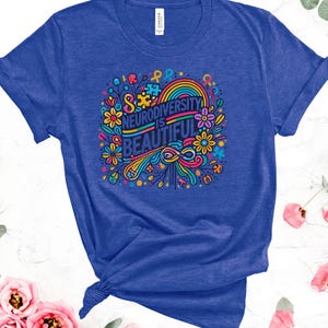 May include: A royal blue t-shirt with a colorful graphic design featuring flowers, a rainbow, and the text "Neurodiversity is Beautiful".