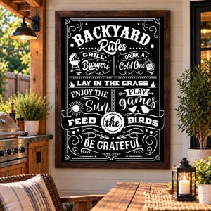 May include: A rectangular wall sign with a dark wood frame featuring white text on a black background that reads BACKYARD Rules, Grill Burgers, Drink A Cold One, Lay In The Grass, Enjoy The Sun, Play Games, Feed the Birds, and Be Grateful.
