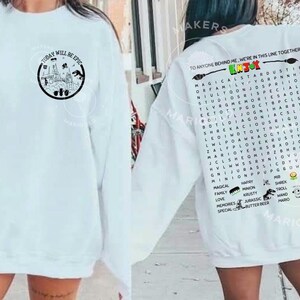 May include: White sweatshirt with the text "TODAY WILL BE EPIC" and a circular graphic on the front. The back features a word search with the text "TO ANYONE BEHIND ME, WE'RE IN THIS LINE TOGETHER."
