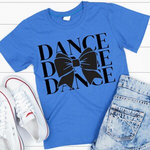 May include: A royal blue t-shirt with a black bow and the word "DANCE" repeated three times.
