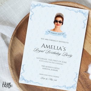 May include: A blue and white invitation with a photo of a woman wearing a tiara and sunglasses. The text reads "Amelia's Royal Birthday Party" and includes details about the event, including the date, time, location, and dress code. The RSVP deadline is May 15th.