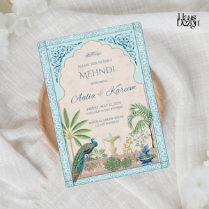 Puede incluir: Una tarjeta de invitación azul y blanca con un diseño de pavo real. La tarjeta dice "Por favor, únase a nosotros para un Mehndi en honor a Aalia & Kareem. Viernes, 31 de mayo de 2024, 7:00 p. m., Mughal Green House, 123 Anywhere St."