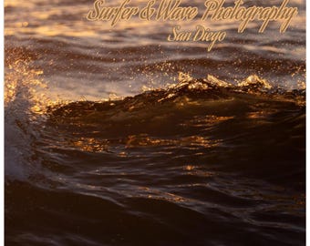May include: A calendar featuring a photograph of a wave at sunset. The text "Surfer & Wave Photography San Diego" is displayed in a stylized font. The photographer's name, Nico Yeager, is also visible, along with "26-27 Calendar".