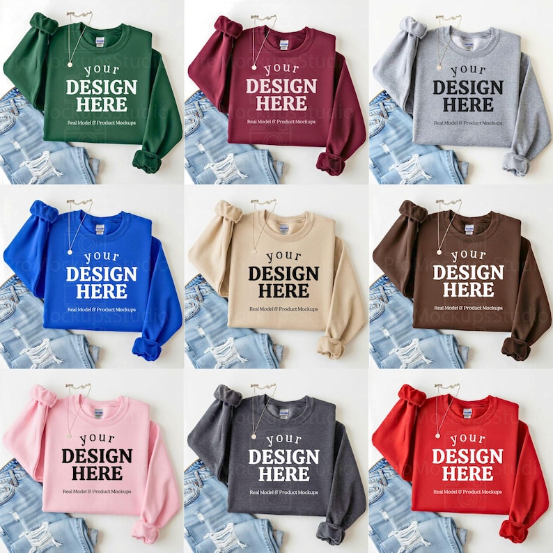 May include: A collection of nine crewneck sweatshirts in various colors, including green, burgundy, gray, blue, beige, brown, pink, charcoal, and red. Each sweatshirt displays the text "YOUR DESIGN HERE" in a bold, white font. The sweatshirts are paired with light-wash denim jeans.