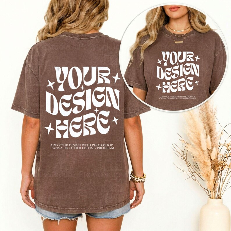 May include: A brown t-shirt with the text "YOUR DESIGN HERE" in white, with star accents. The text "ADD YOUR DESIGN WITH PHOTOSHOP, CANVA OR OTHER EDITING PROGRAM" is below the main text. The shirt is worn with denim shorts.