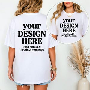 May include: White t-shirt with the text "your DESIGN HERE" in a bold, black font. The text "Real Model & Product Mockups" is below the main text. The shirt is being modeled, showcasing the design on the front and back.
