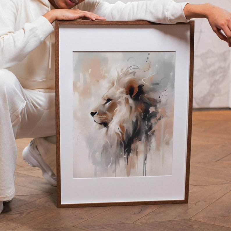 May include: A framed watercolor painting of a white lion with a brown mane. The lion is looking to the left and the background is a soft, abstract wash of colors.