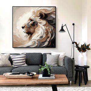 May include: A framed artwork depicts a lion's profile with a flowing mane. The artwork features shades of brown, white, and gray. The lion artwork hangs above a gray sofa with decorative pillows. A wooden coffee table and black side tables complete the living room setting.