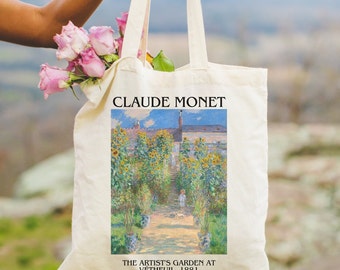 May include: A white canvas tote bag with a printed image of Claude Monet's painting "The Artist's Garden at Vetheuil, 1881". The painting depicts a garden with sunflowers and a small figure walking on a path.