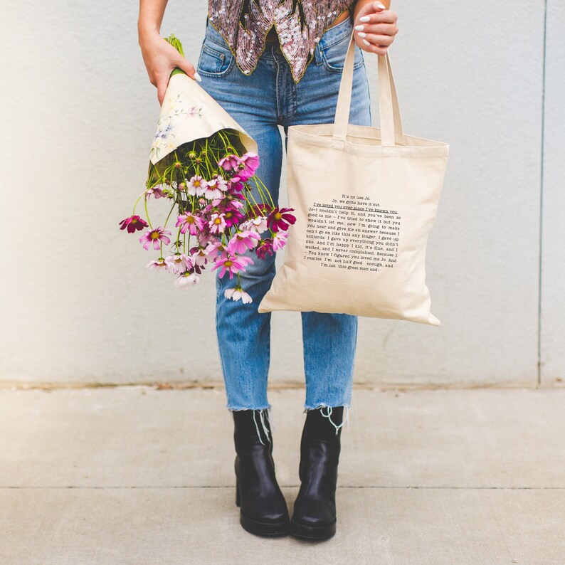 May include: A person is holding a tote bag with a quote printed on it. The quote reads: "It's not that we were so good, we just loved you more. You came along and you were so good to us. We gave you all we had. We didn't let you down, and you've been so good to me. I'm an answer because you're a question. I'm a song because you're a dance. I'm a fighter because you're a war. I give up everything I own, and I never complained. Because I love you. You know I fought you. It's listed, you know. I'm not your good man, and I'm not half good enough. I'm just the great man and..."