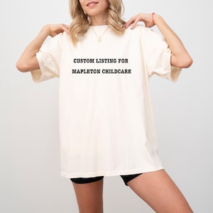 May include: A white t-shirt with black text that reads "CUSTOM LISTING FOR MAPLETON CHILDCARE".