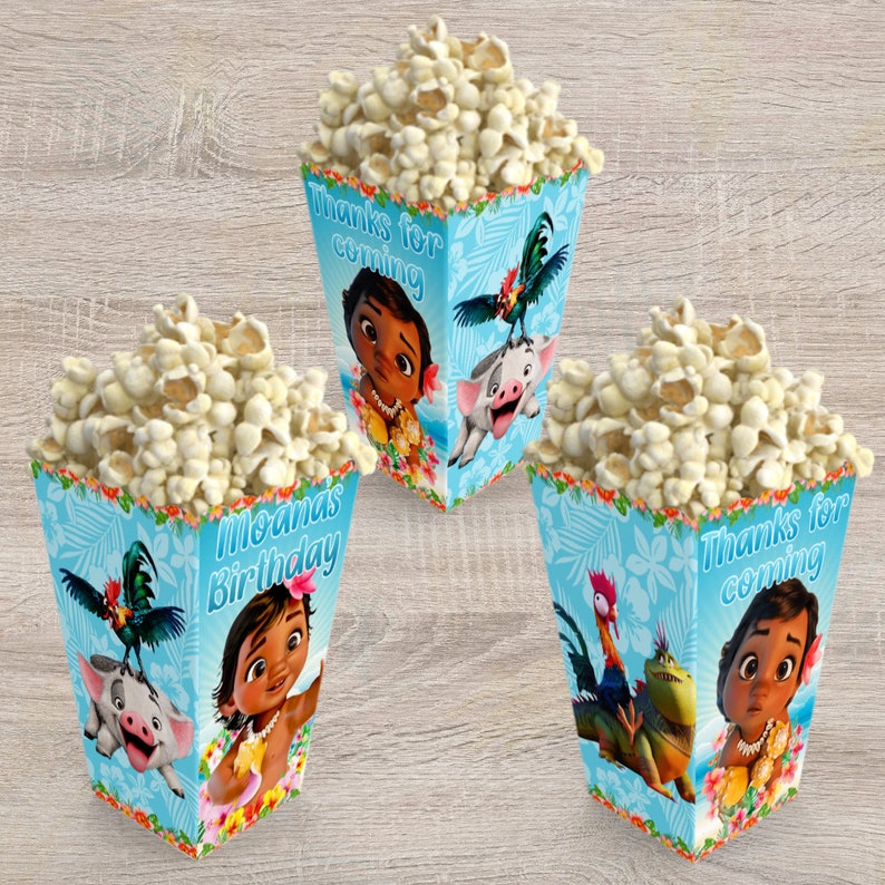 May include: Three blue and white popcorn boxes with Moana characters and the text "Moana's Birthday" and "Thanks for coming".