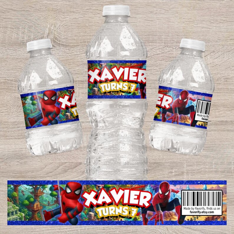 May include: Three clear plastic water bottles with custom labels featuring a red and blue superhero character, a blue glitter border, and the text XAVIER TURNS 7. A flat version of the rectangular label is displayed below with a barcode.