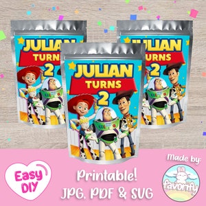May include: Three silver pouches with a colorful design featuring characters from Toy Story. The pouches read "JULIAN TURNS 2" in large yellow letters. The bottom of the image says "Printable! JPG, PDF & SVG".