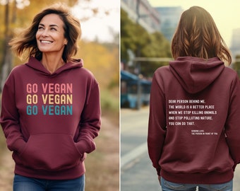 May include: Burgundy hoodie with a message on the front that says "Go Vegan" three times in rainbow colors. The back of the hoodie has a message that says "Dear person behind me. The world is a better place when we stop killing animals and stop polluting nature. You can do that."