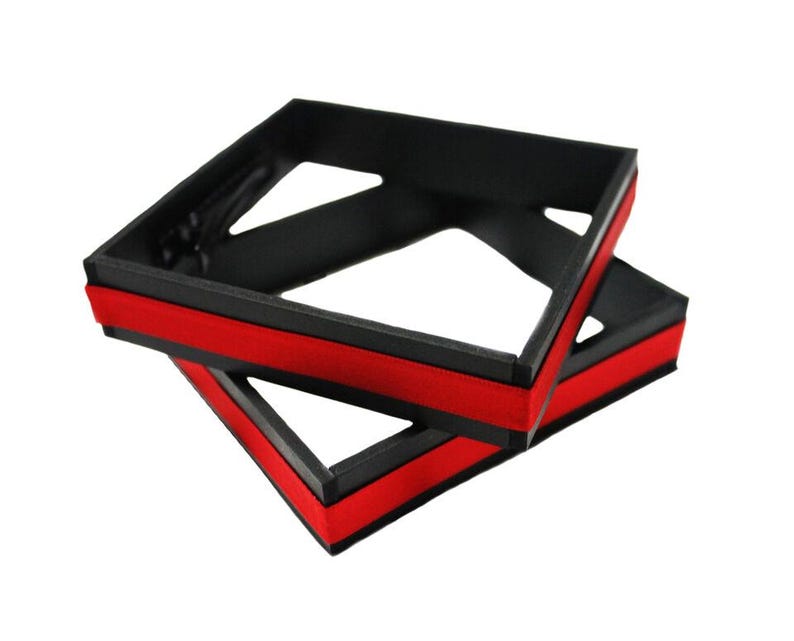 May include: Two black square-shaped frames with red trim. The frames are stacked on top of each other.