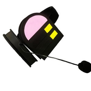 May include: Black headset with a pink and yellow design. The headset has a microphone attached to the earpiece.