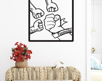 May include: Black and white silhouette of five fists clasped together, with the word "Family" written on a banner. The fists are labeled with the names "Liam", "Olivia", "Emilia", and "Ethan".