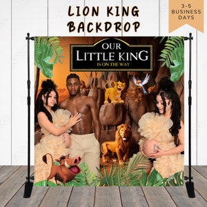 May include: A Lion King themed backdrop for a baby shower. The backdrop features a jungle scene with a lion, a warthog, and a bird. The text "Our Little King Is On The Way" is displayed in a black banner.