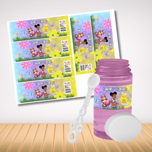 May include: Four printable water bottle labels with a cartoon girl and bunny holding an Easter egg. The labels say "Happy Easter". A pink bubble bottle with a white lid and wand. The bottle label says "Happy Easter" with a cartoon girl and bunny holding an Easter egg.