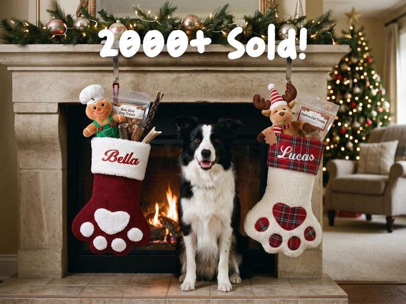 May include: Two paw-shaped Christmas stockings hanging from a fireplace mantel. The left stocking is maroon with the name Bella and a gingerbread plush. The right stocking is white with a plaid cuff, the name Lucas, and a reindeer plush.