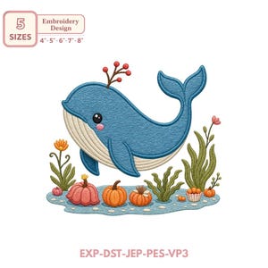 May include: An embroidery design featuring a blue whale with a cream-colored belly, a small sprig of red berries on its head, and pink cheeks. Below the whale are orange pumpkins, green seaweed, and orange flowers on a light blue water base.