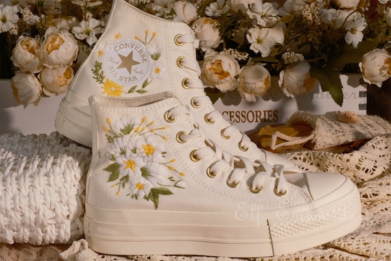 white converse with gold eyelets
