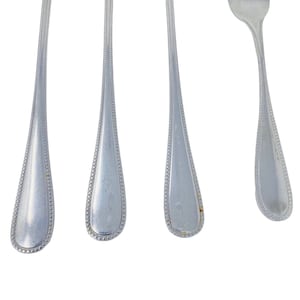 May include: Four silver forks with beaded edges. The forks are arranged in a row, with the tines of the forks facing the viewer.