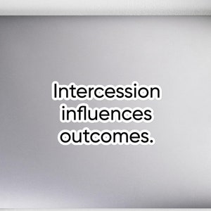 May include: A white laptop with a black sticker that says "Intercession influences outcomes."