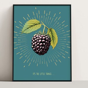 May include: Framed art print featuring a detailed illustration of a blackberry with green leaves and a teal background. The design includes a sunburst effect and the text "IT'S THE LITTLE THINGS..." in a simple font. The artwork is enclosed in a black frame.