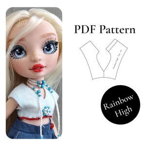 May include: A doll with long blonde hair, blue eyes, and freckles wearing a light blue cropped top with a red hem and a white beaded necklace. Next to the doll is a PDF Pattern for a top and a black circle with the text Rainbow High.