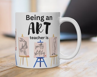 May include: White ceramic mug with a black design that reads "Being an ART teacher is pretty sketchy". The design features three easels with drawings of a fish, a bird, and a penguin.