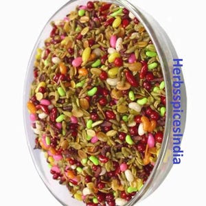 May include: A bowl of colorful Indian snack mix, called "pan masala", with a variety of ingredients including fennel seeds, candy pieces, and nuts.