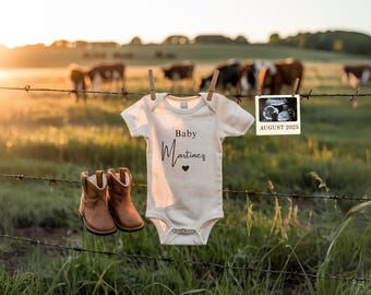 May include: A baby bodysuit with the text "Baby Martinez" and a heart, hanging on a barbed wire fence with small brown cowboy boots. An ultrasound image is displayed with the text "August 2025". Cows graze in the background.