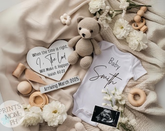 May include: A white heart-shaped wooden sign with the text "When the time is right, I. The Lord Will Make it Happen Isaiah 60:22" and a white wooden sign with the text "Arriving March 2025". A white onesie with the text "Baby Smith" and a teddy bear. A white blanket with white flowers and wooden toys.