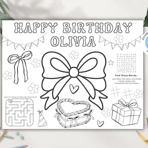 May include: Black and white coloring page with the text "HAPPY BIRTHDAY OLIVIA". Includes illustrations of bows, flowers, a heart-shaped cake, a gift box, and a maze. Features the text "Find These Words:" and a list of words.