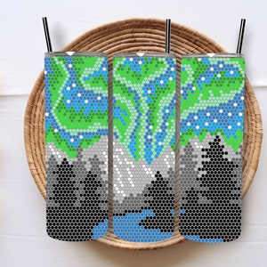 May include: Three stainless steel tumblers with a geometric pattern of green, blue, and white. The pattern resembles a mountain scene with trees and a lake.