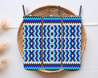 May include: Three stainless steel tumblers with a blue, black, and white geometric pattern. The tumblers are sitting in a woven basket.
